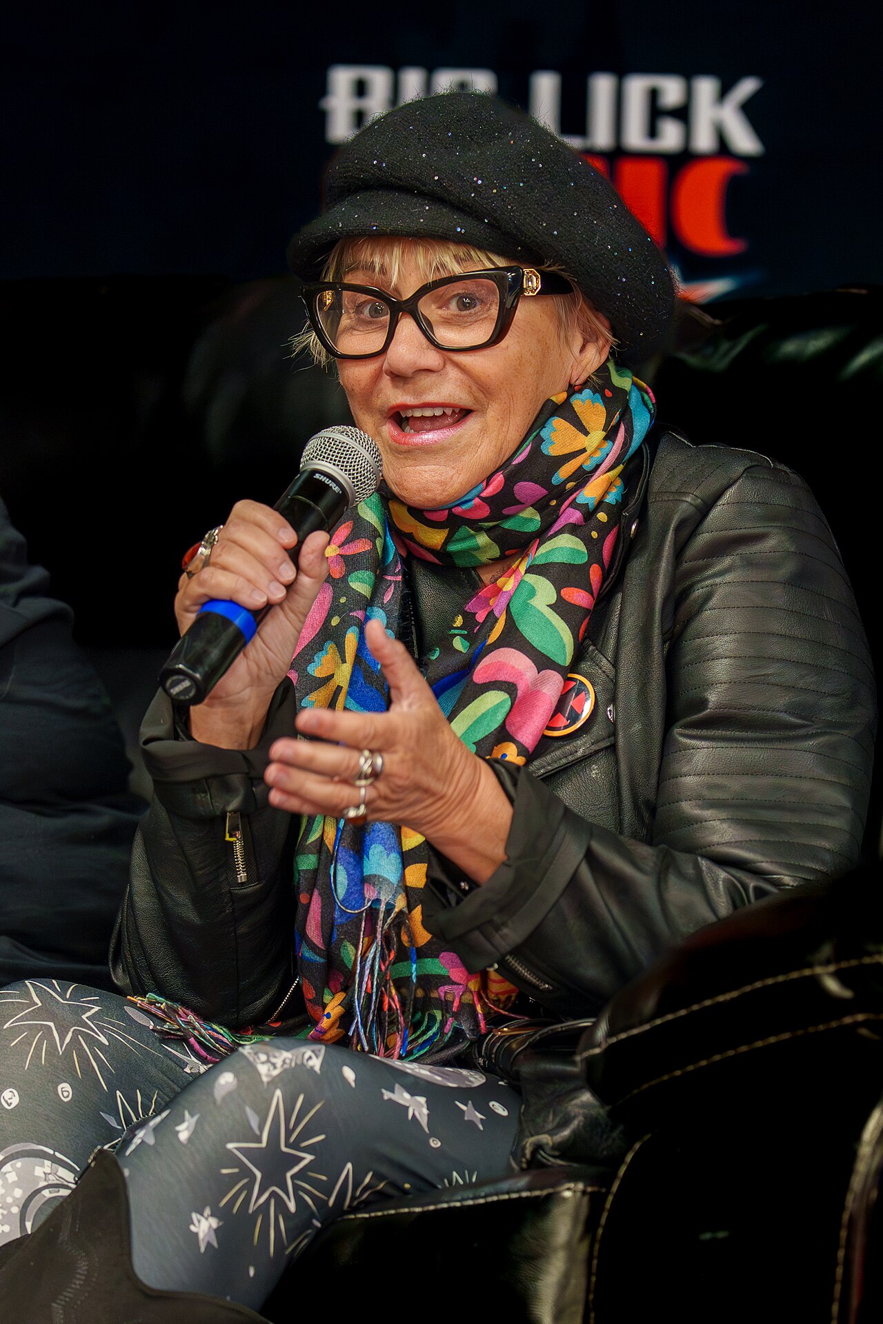 Voice actor Lenore Zann speaking into a microphone at Big Lick Comic Con in February 2026.