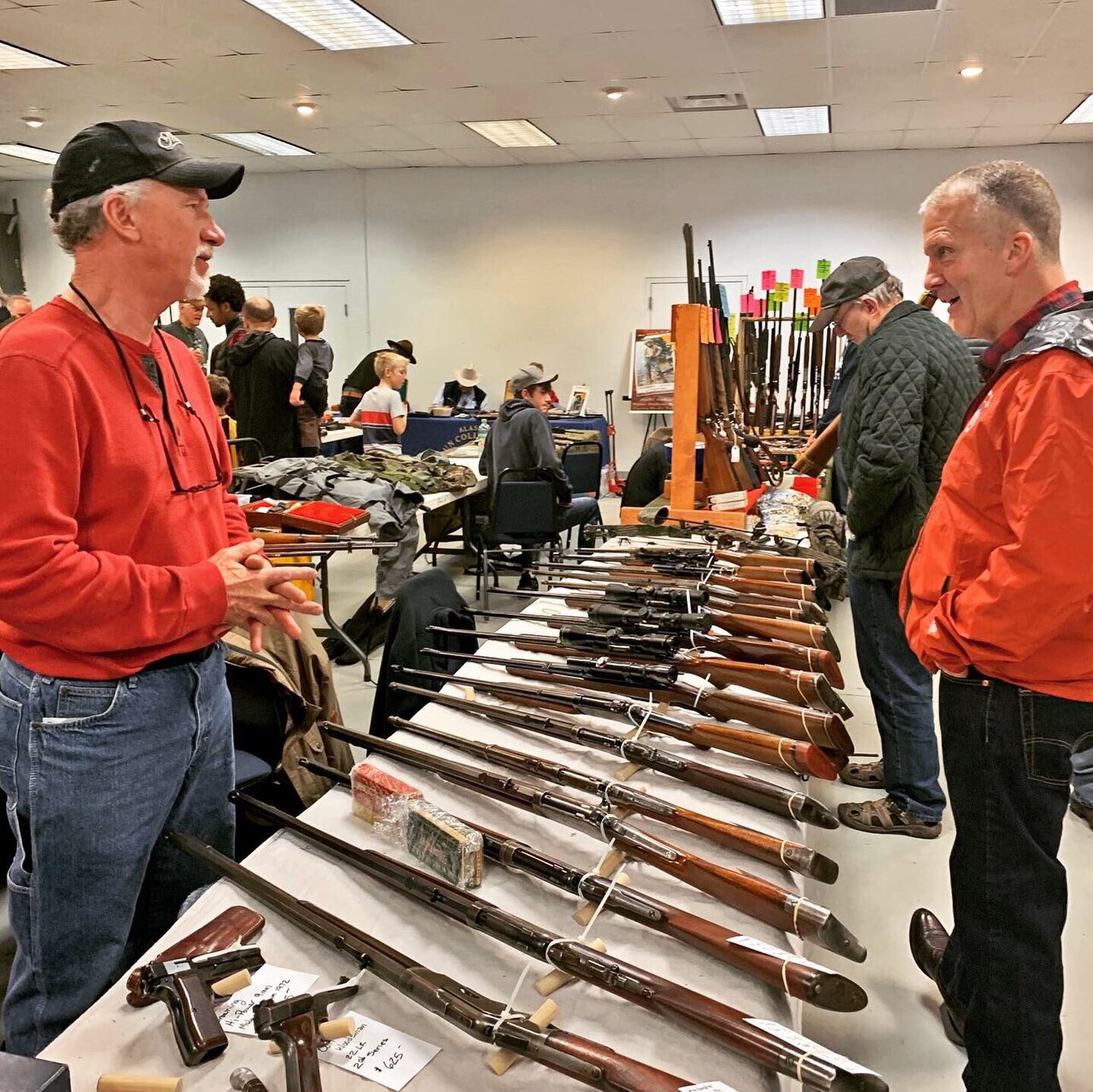 Dan Sullivan speaking with visitors at an Eagle River Lions Club gun show.