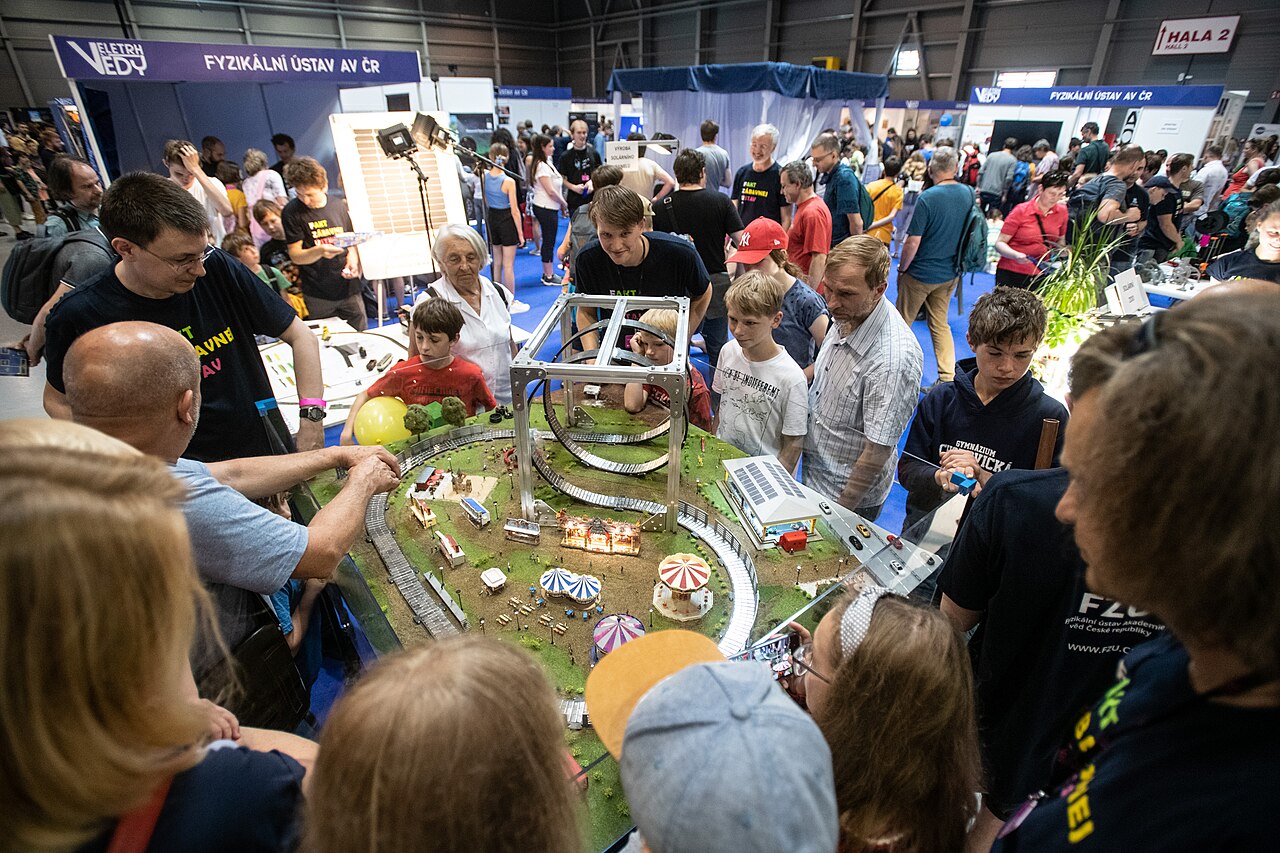 Visitors around an interactive exhibit at a public science fair.