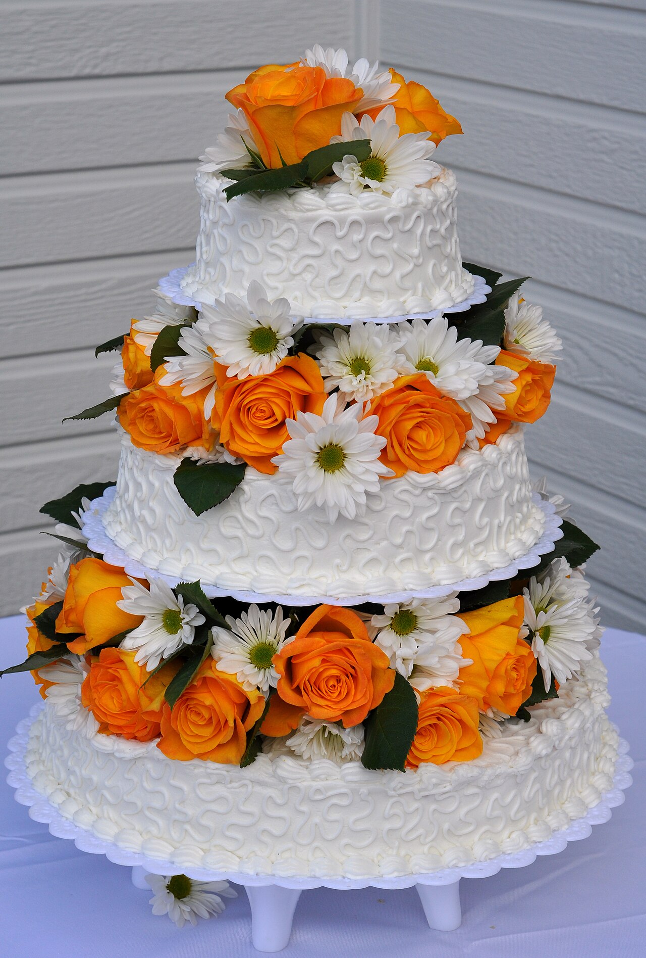 A wedding cake decorated with flowers.